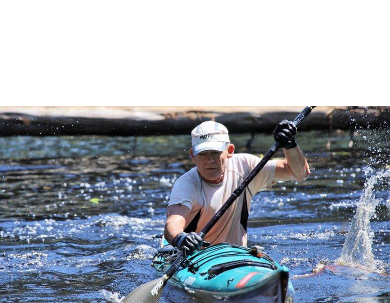 Kayakers paddling clear spring waters